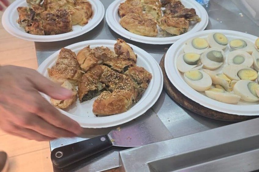 A person serving food from a tray. 2