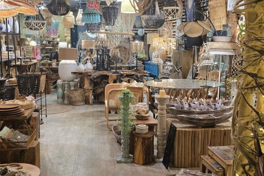 A cluttered indoor market with various items like baskets, lamps, and furniture. 4