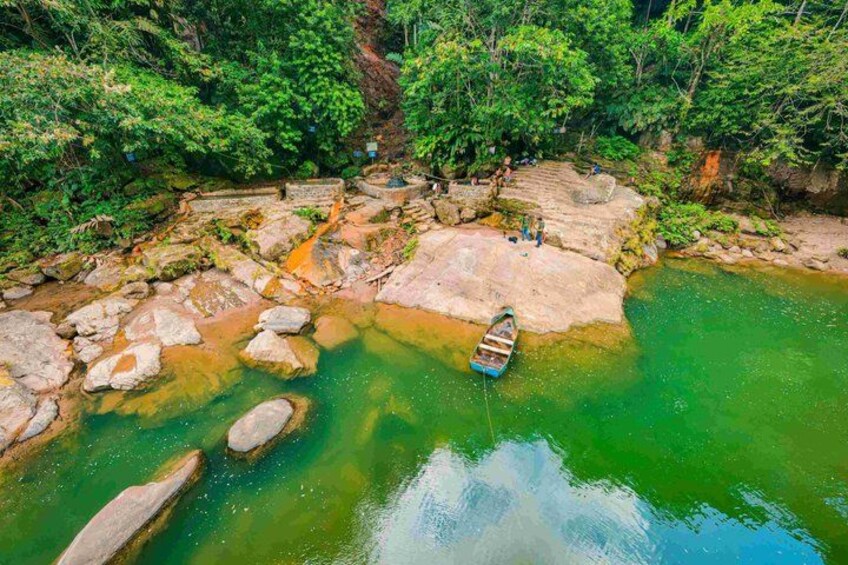 A river with clear water, rocks, and a boat. 3