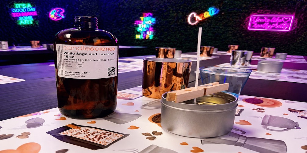 A bottle of Candlescience White Sage and Lavender, a candle-making kit, and a wooden block on a table with a colorful tablecloth. 3