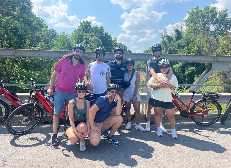 A group of people with bicycles on a bridge. 4