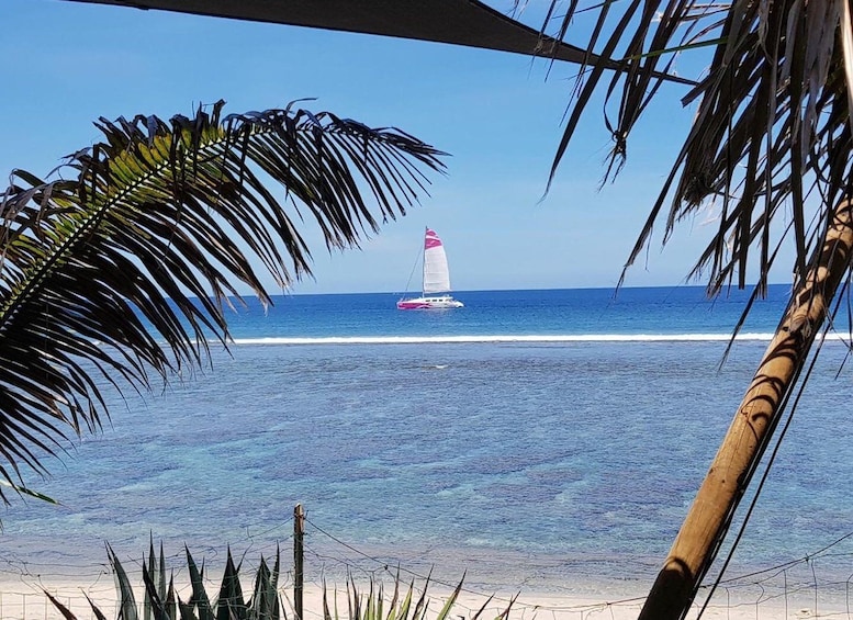 A sailboat on the ocean with a clear sky. 3