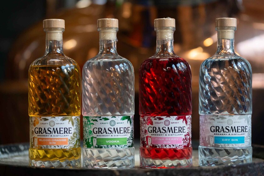 Four bottles of Grasmere brand beverages on a shelf. 4