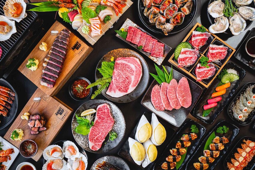 A variety of sushi and sashimi dishes, including raw fish, vegetables, and garnishes. 3