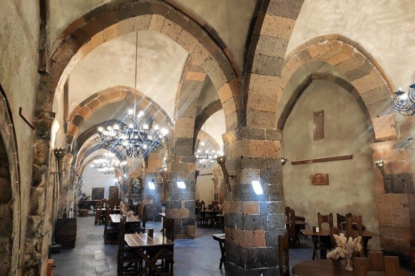 A historic building with arched ceilings and stone walls. 2