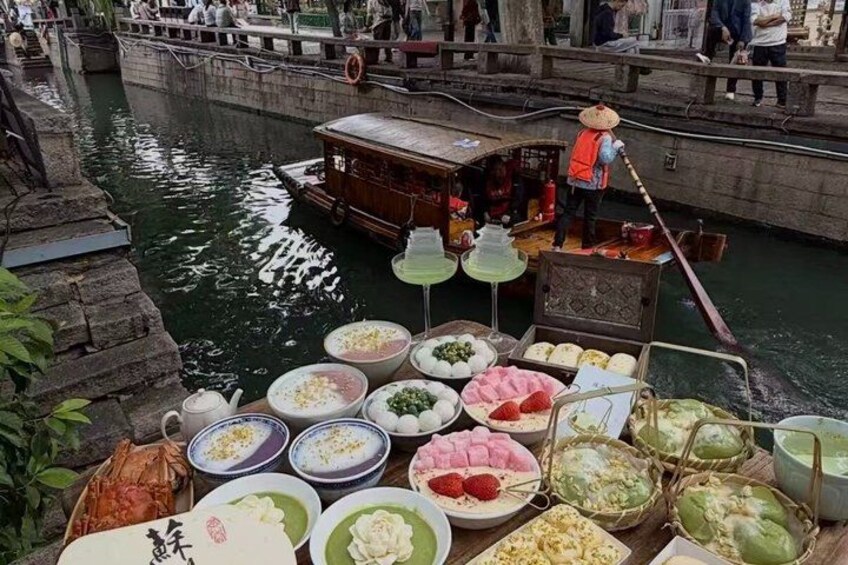 A boat with various dishes and a person in a conical hat. 5