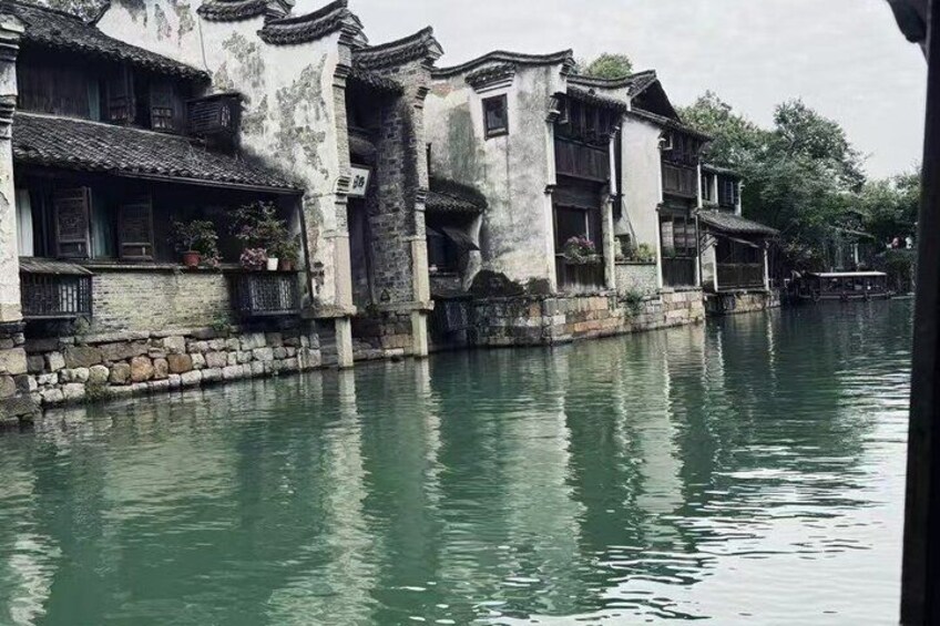 Traditional buildings along a calm river. 2