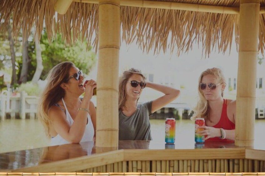Three people at a beachside bar with drinks. 5