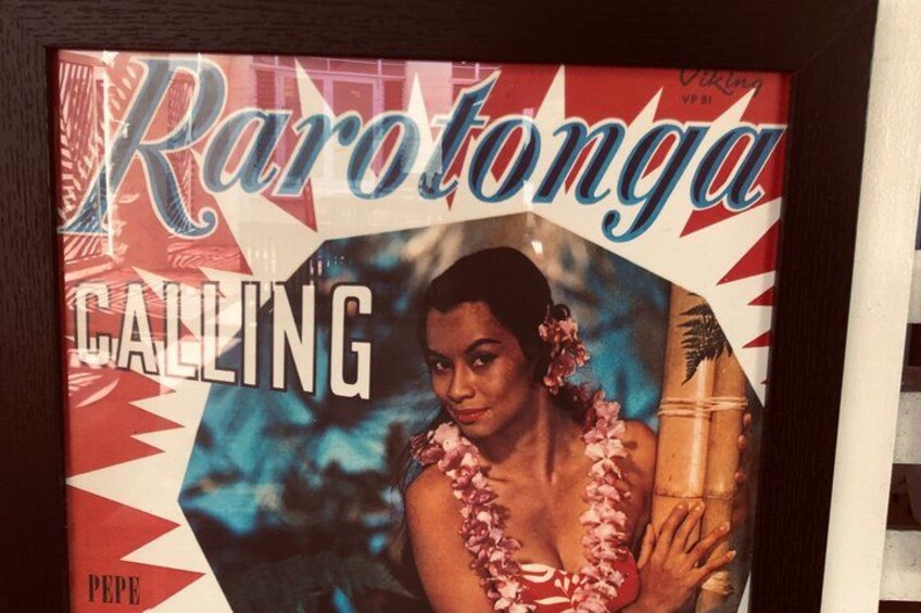 A magazine cover titled 'Rarotonga Calling' with a person wearing a floral lei. 2