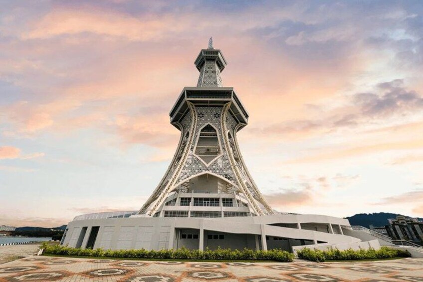 A modern architectural building with a unique tower structure, surrounded by a landscaped area. 3