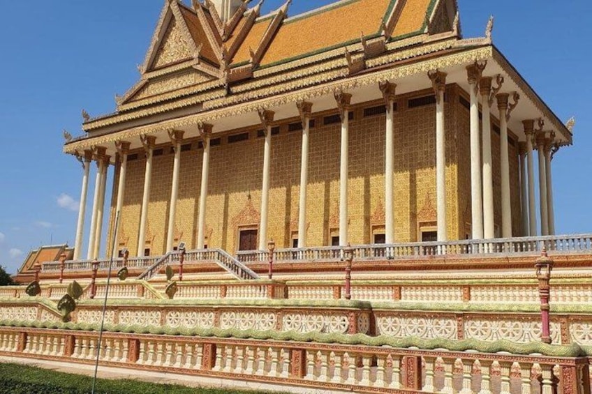 A large, ornate building with a multi-tiered roof, columns, and intricate decorative patterns. 2