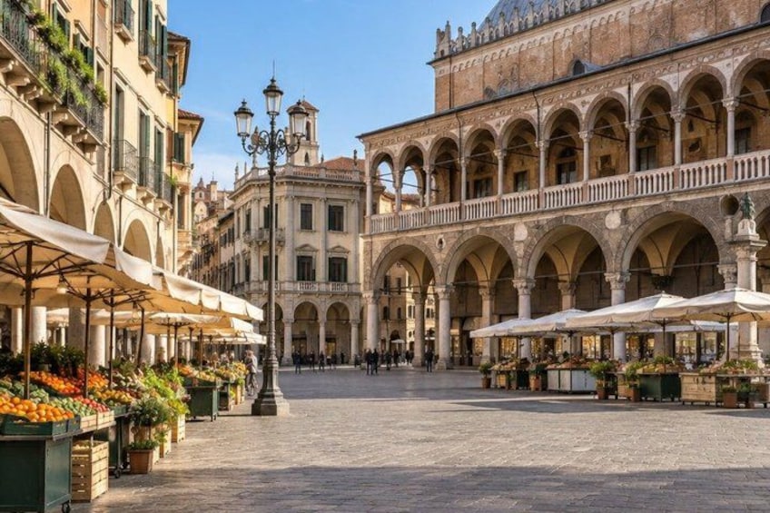 A historic square with arches, outdoor cafes, and a fountain. 2