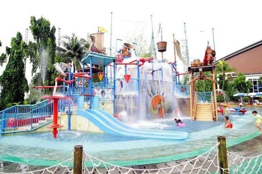 A water park with slides, a water splash area, and a wooden play structure. 4
