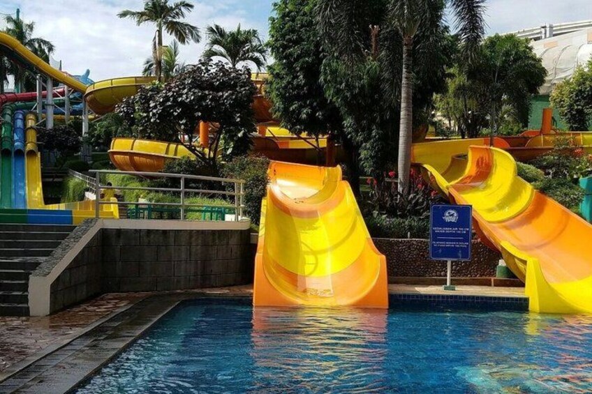 A water park with multiple slides and a swimming pool. 3