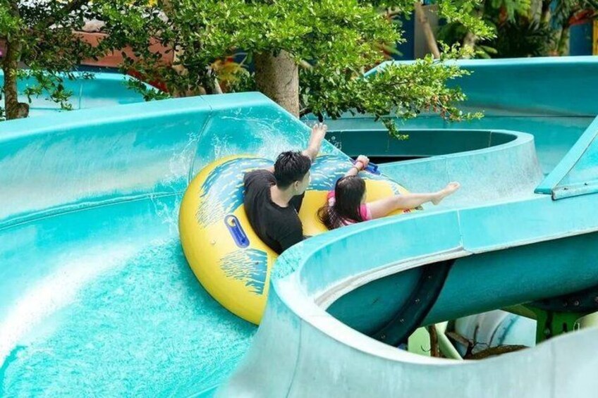 A water slide with two people in yellow tubes. 4