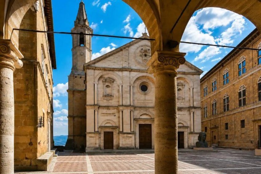 A historical building with a bell tower, arches, and a clear sky. 3