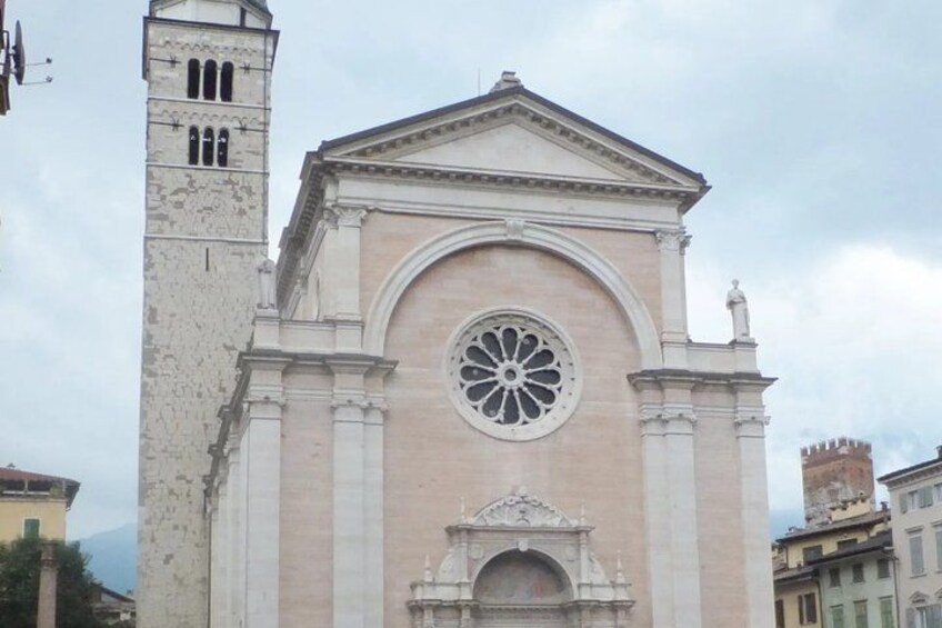 A historic church with a prominent rose window, a bell tower, and classical architecture. 4