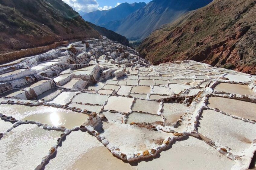 Terraced salt flats with a mountainous backdrop. 4