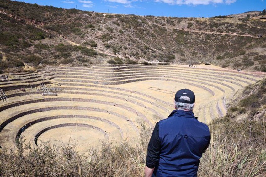 A person standing in front of terraced fields. 5