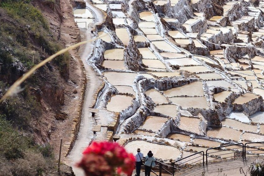 Terraced salt flats with a pathway and people walking. 2