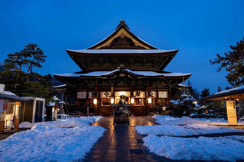 A traditional Japanese building with a snow-covered entrance and wooden architecture. 3