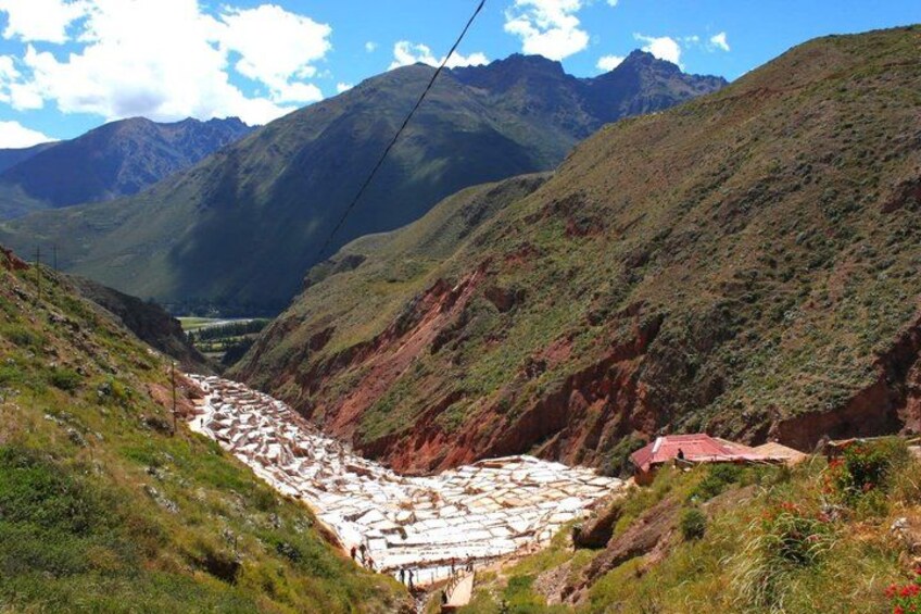 A valley with terraced fields, a river, and mountains in the background. 4