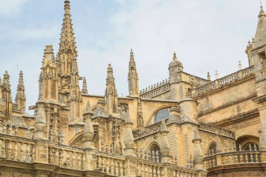A historic building with ornate Gothic architecture, featuring pointed arches and intricate stone carvings. 3