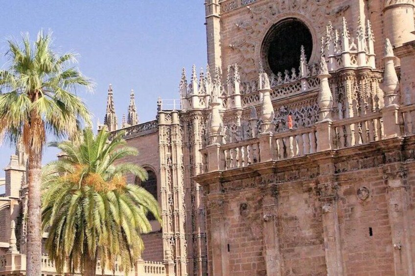 A historic building with intricate Gothic architecture, including pointed arches and detailed stonework. 4
