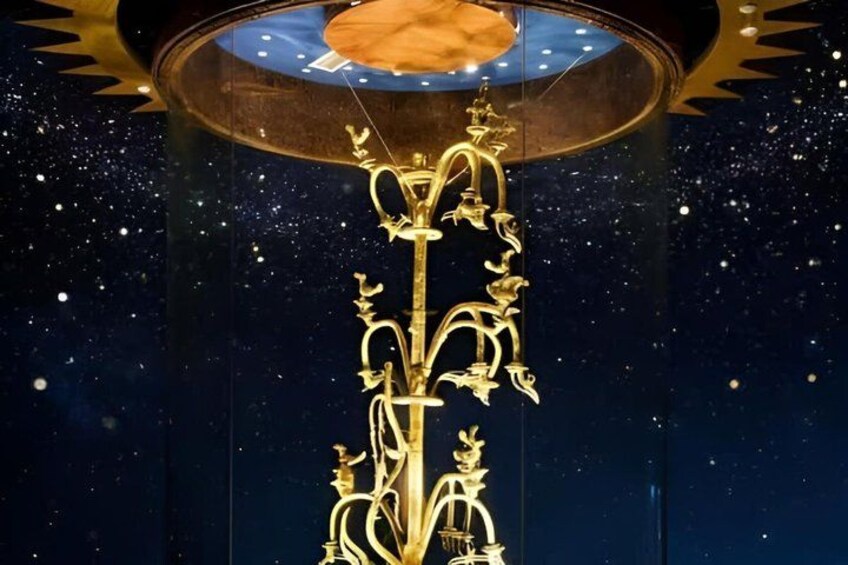 A golden ornamental structure with intricate designs, set against a dark background with a starry sky effect. 3
