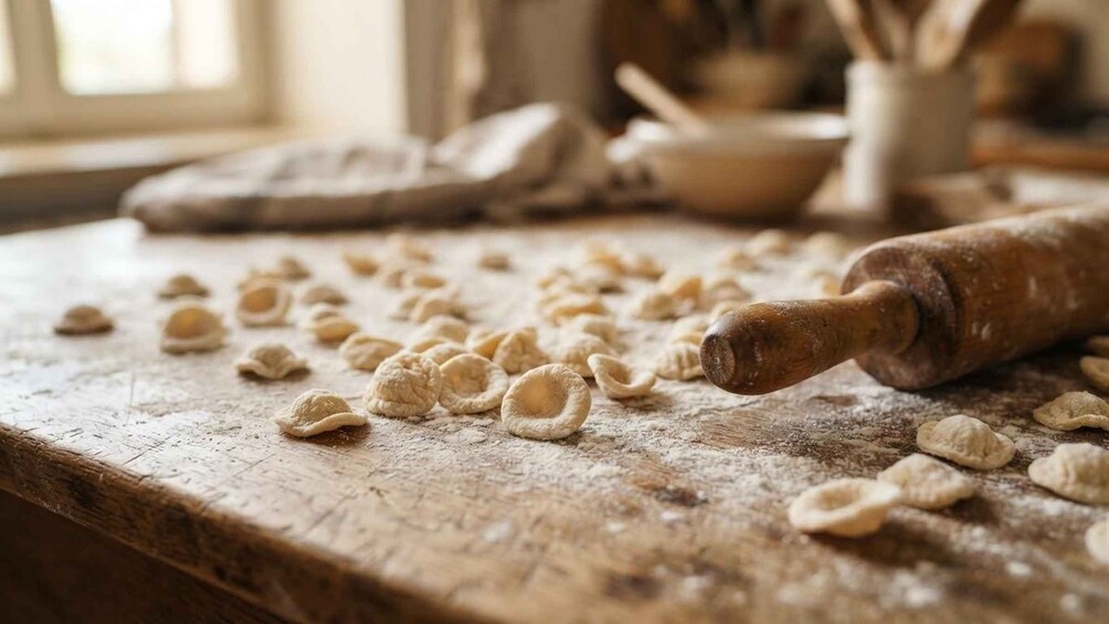 A wooden surface with flour dusting, dough pieces, and a rolling pin. 4