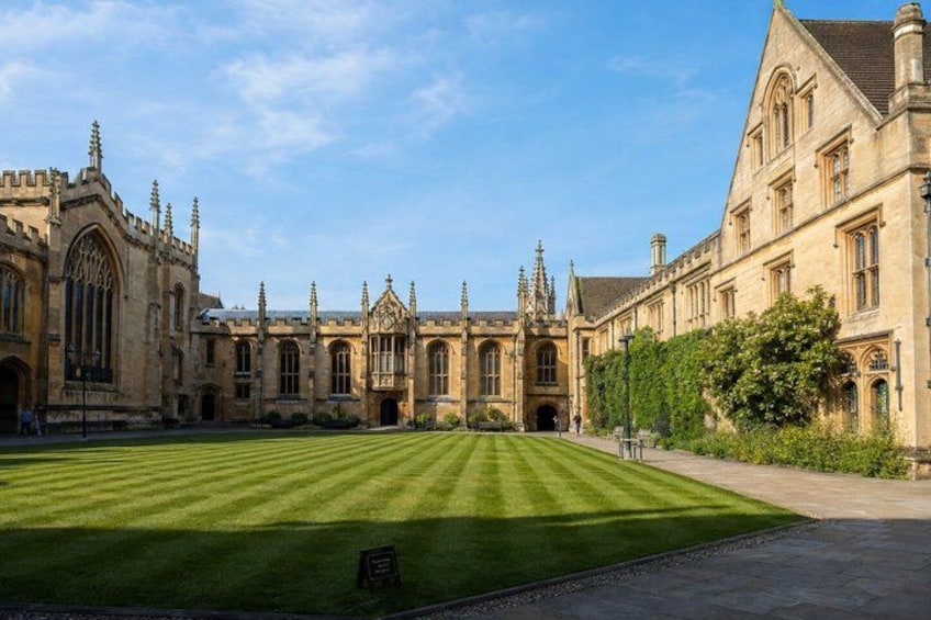 A historic building with large windows and a well-manicured lawn. 4
