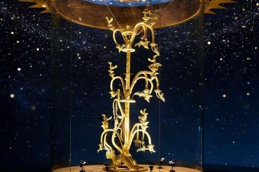 A golden sculpture with intricate designs, set against a starry night sky backdrop. 2