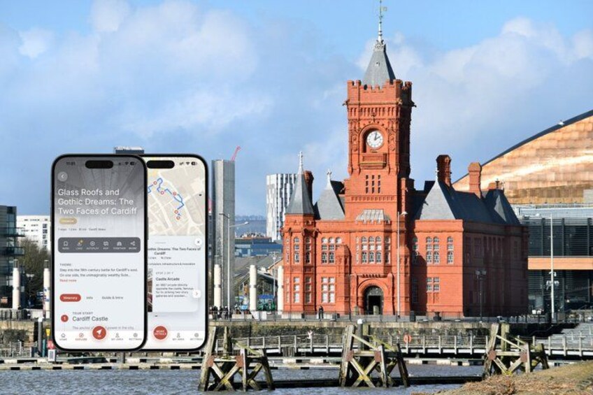 A historic building with a clock tower, a modern glass structure, and a river in the foreground. 1
