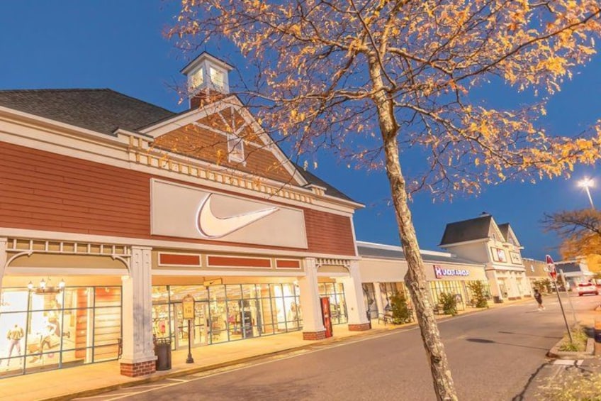 A storefront with a prominent Nike logo, a street with a tree in the foreground, and a building with a sign that reads 'Kessler.' 3