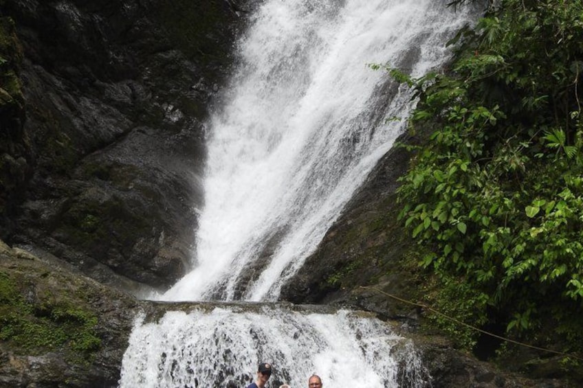 A waterfall cascading down a rocky cliff surrounded by lush greenery. 4