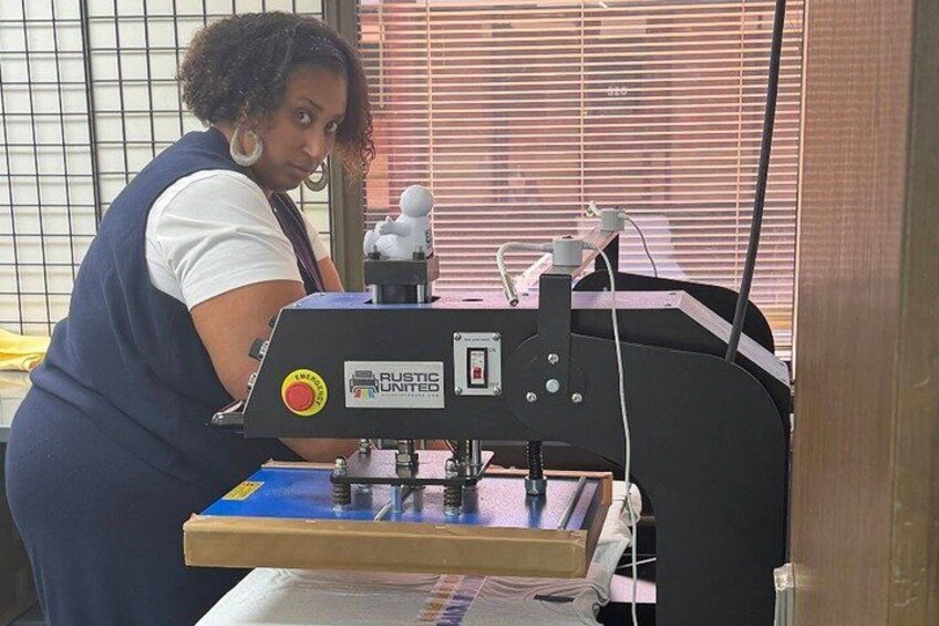 A person operating a machine with a control panel and a blue surface. 5