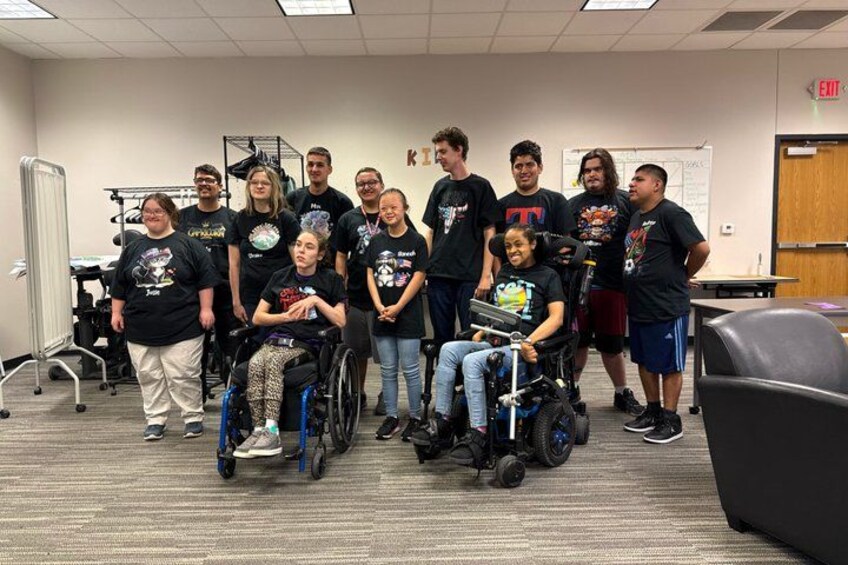 A group of people in a classroom with wheelchairs. 2