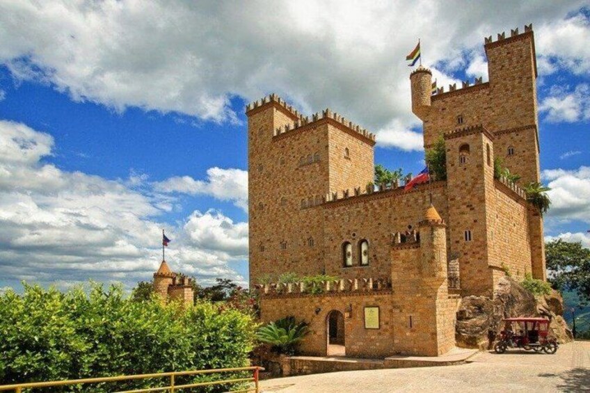 A castle with two towers, a flag, and a flagpole. 4