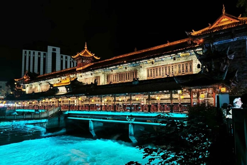 A traditional Chinese building with ornate architecture, a bridge, and a river. 3