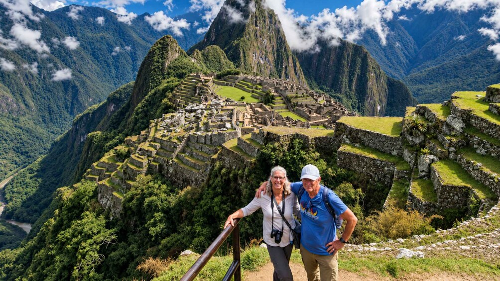Machu Picchu, muinainen inkojen kaupunki, jossa turisteja seisoo näköalatasanteella. 5