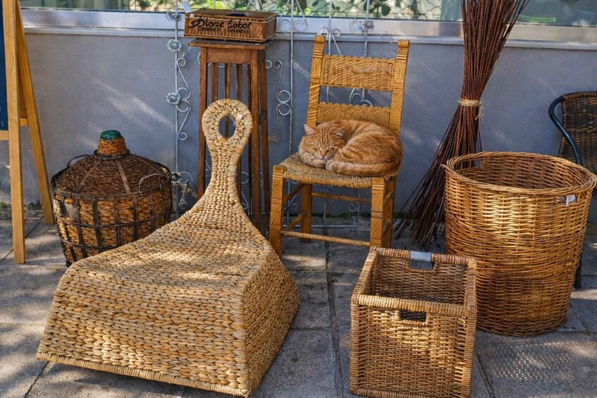 Wicker furniture including a chair, a table, and a basket. 2