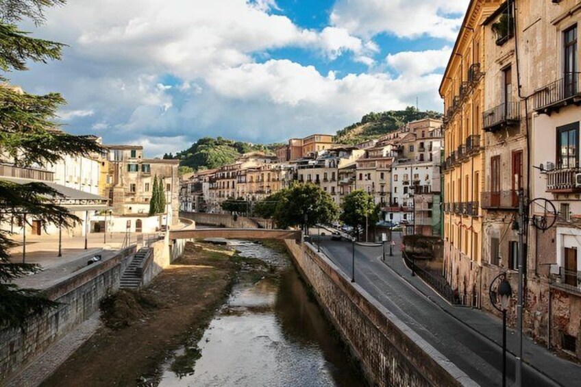 A river running through a historic town with old buildings and a bridge. 3