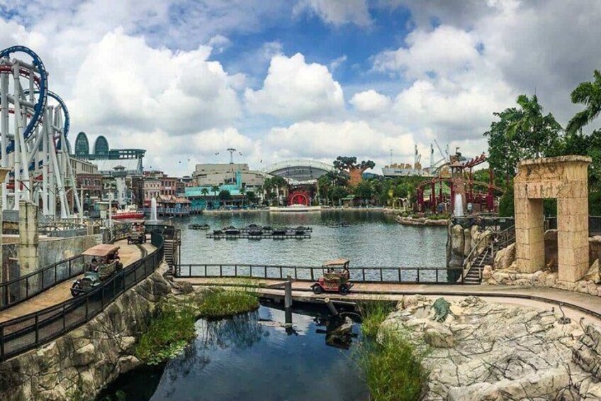 A water park with a roller coaster, a Ferris wheel, and a bridge. 5