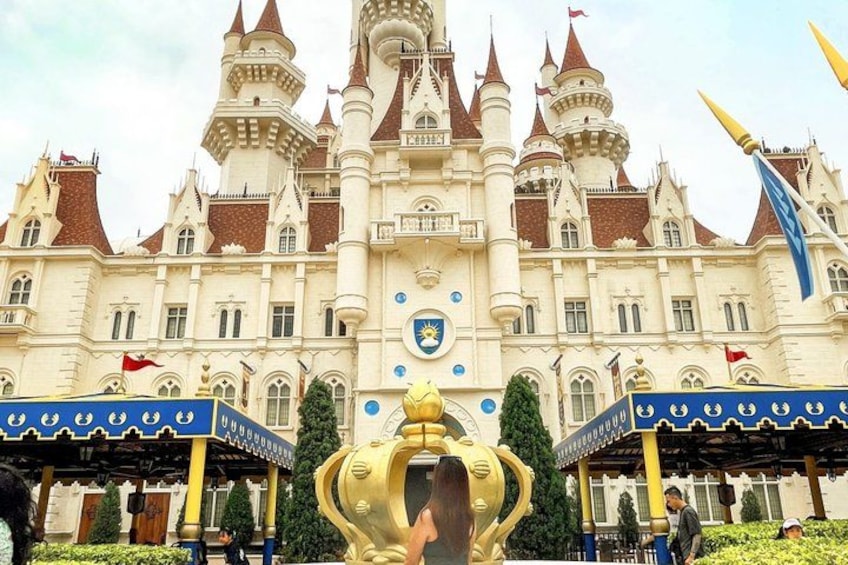 A large castle-like building with multiple towers and flags. 4