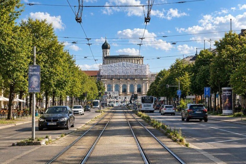 A tram track, a tram, and a building with a dome. 5