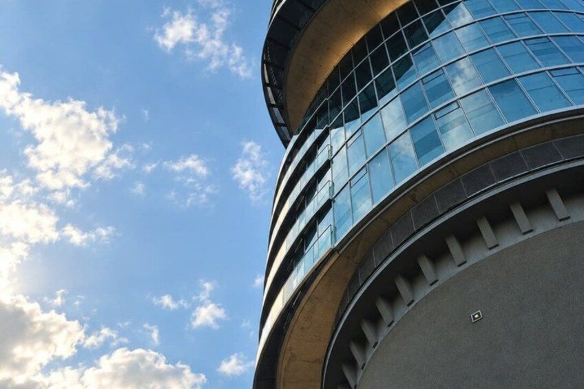 A modern building with curved glass windows and a circular design. 4