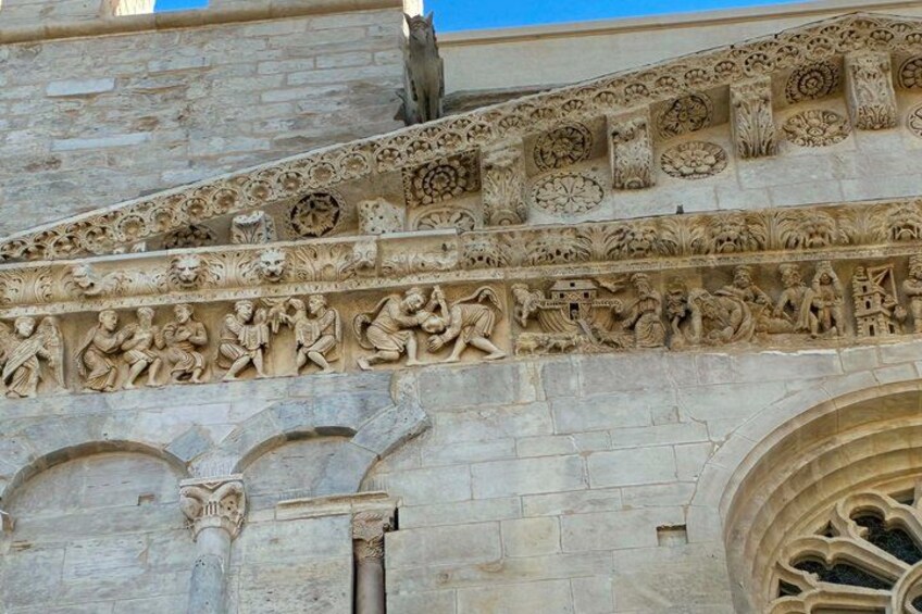 A detailed stone facade with intricate carvings and a gothic arch. 4