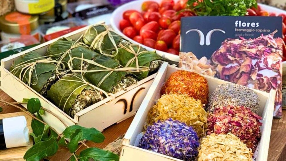 A table with various food items, including wrapped dishes and colorful shredded ingredients. 2