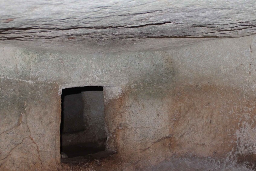 A stone structure with a small rectangular opening. 5