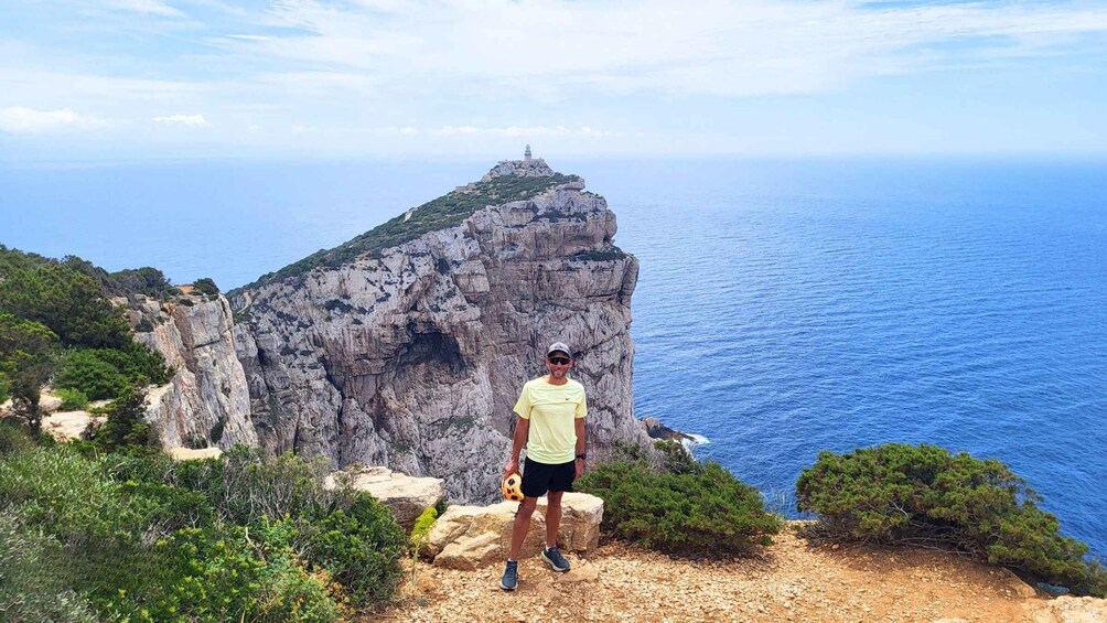A person standing on a rocky cliff overlooking a vast ocean. 2
